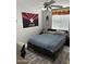 Cozy bedroom with a ceiling fan, comfortable bed, and unique wall decorations at 9911 W Riverside Ave, Tolleson, AZ 85353