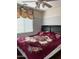 Bedroom featuring a queen-sized bed with a floral blanket and a ceiling fan, with a window at 9911 W Riverside Ave, Tolleson, AZ 85353