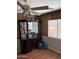 Dining room with wood floors, a china cabinet, and a window covered with blinds and a decorative valance at 9911 W Riverside Ave, Tolleson, AZ 85353