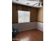 Dining room with wood floors, and a window covered with blinds and a decorative valance at 9911 W Riverside Ave, Tolleson, AZ 85353