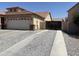 Extended driveway leading to a two-car garage and a gated RV parking area at 9911 W Riverside Ave, Tolleson, AZ 85353