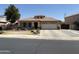 Charming single-story home with a well-manicured front yard and a two-car garage at 9911 W Riverside Ave, Tolleson, AZ 85353