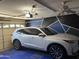 A well-lit garage featuring modern ceiling fan and vehicle, perfect for secure parking at 9911 W Riverside Ave, Tolleson, AZ 85353