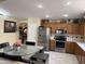 Stylish kitchen with stainless steel appliances, light wood cabinets, and decorative accents at 9911 W Riverside Ave, Tolleson, AZ 85353