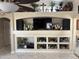 Living room with built-in shelves filled with decorative items, and a TV above the shelves at 9911 W Riverside Ave, Tolleson, AZ 85353