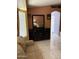 This living room with tile floors and a black dresser is bright with natural light at 9911 W Riverside Ave, Tolleson, AZ 85353