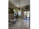 Bright living room with tile floors, a ceiling fan, large windows, a sliding glass door, and furniture at 9911 W Riverside Ave, Tolleson, AZ 85353