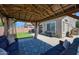 Serene covered patio with comfortable seating, a cozy rug, and well-manicured lawn at 9918 E Escondido Ave, Mesa, AZ 85208