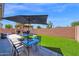 Beautiful backyard with artificial grass, patio seating, and an outdoor cabana at 9918 E Escondido Ave, Mesa, AZ 85208