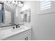 Bright bathroom featuring a large mirror, white vanity and black fixtures at 9918 E Escondido Ave, Mesa, AZ 85208