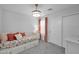 Bright bedroom featuring a daybed, floral bedding, and closet with sliding doors at 9918 E Escondido Ave, Mesa, AZ 85208