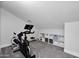 Bonus room with fitness equipment and built-in shelving offers space for exercise and storage at 9918 E Escondido Ave, Mesa, AZ 85208