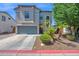 Beautiful two-story home with a gray stucco exterior, landscaped yard, and a two-car garage at 9918 E Escondido Ave, Mesa, AZ 85208