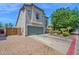 Side view of a beautiful two-story home with gray stucco and a well-maintained front yard at 9918 E Escondido Ave, Mesa, AZ 85208