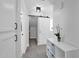 Bright hallway featuring white walls, a sliding barn door and gray carpet at 9918 E Escondido Ave, Mesa, AZ 85208