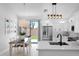 A modern kitchen featuring white cabinets, stainless steel appliances, and a stylish dining area at 9918 E Escondido Ave, Mesa, AZ 85208