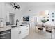 Kitchen featuring an open floor plan with modern white cabinetry, stainless appliances, and adjacent dining area at 9918 E Escondido Ave, Mesa, AZ 85208
