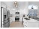 A modern kitchen with white cabinetry, stainless steel appliances, and a bright, open design at 9918 E Escondido Ave, Mesa, AZ 85208
