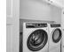 Modern laundry room features a side-by-side washer and dryer and ample shelving at 9918 E Escondido Ave, Mesa, AZ 85208
