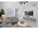 Well-lit living room with large windows, soaring ceilings, modern furniture, and a ceiling fan at 9918 E Escondido Ave, Mesa, AZ 85208