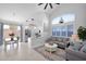 Open living space with a view of the kitchen, featuring modern lighting and neutral decor at 9918 E Escondido Ave, Mesa, AZ 85208