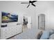 Bright main bedroom showcasing a high ceiling, open door and a TV with scenic views at 9918 E Escondido Ave, Mesa, AZ 85208