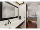 Updated bathroom features a modern vanity, sleek fixtures, and ample lighting and large mirror at 10410 N Cave Creek Rd # 2229, Phoenix, AZ 85020