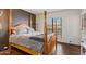 The bedroom features a wooden bed frame, wood floors, and a large window at 10410 N Cave Creek Rd # 2229, Phoenix, AZ 85020