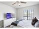 Bright bedroom featuring a ceiling fan, large window and white dresser at 10410 N Cave Creek Rd # 2229, Phoenix, AZ 85020
