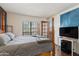 Spacious bedroom with wooden bed frame, TV, wood floors and a window at 10410 N Cave Creek Rd # 2229, Phoenix, AZ 85020