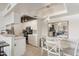 Open-concept kitchen and dining area with modern appliances, white cabinetry, and a breakfast bar at 10410 N Cave Creek Rd # 2229, Phoenix, AZ 85020