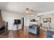 Open-concept living room with hardwood floors connecting to the dining area and kitchen at 10410 N Cave Creek Rd # 2229, Phoenix, AZ 85020