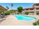 Relaxing community pool area with clear water, surrounding lounge seating, and beautiful landscaping at 10410 N Cave Creek Rd # 2229, Phoenix, AZ 85020