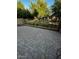 Paved backyard with block wall, iron fence, bench, and grassy area at 1350 S Greenfield Rd # 1219, Mesa, AZ 85206
