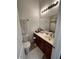 Well-lit bathroom with a single sink vanity, tiled floors, and modern fixtures at 1350 S Greenfield Rd # 1219, Mesa, AZ 85206
