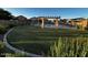 Community pool and seating area with pergola and greenery creating a refreshing and inviting outdoor amenity at 1350 S Greenfield Rd # 1219, Mesa, AZ 85206