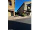 Two-story tan home featuring stone accents, garage, and lush greenery at 1350 S Greenfield Rd # 1219, Mesa, AZ 85206