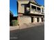 Two-story home featuring stone accents, garage parking, and a wrought-iron balcony at 1350 S Greenfield Rd # 1219, Mesa, AZ 85206