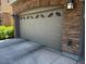 Attached garage door with decorative windows and stone exterior at 1350 S Greenfield Rd # 1219, Mesa, AZ 85206