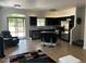 Open-concept kitchen features an island, stainless steel appliances, and modern black cabinetry at 1350 S Greenfield Rd # 1219, Mesa, AZ 85206
