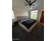 Bright main bedroom features a large window and a king-size bed at 1350 S Greenfield Rd # 1219, Mesa, AZ 85206