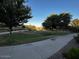 Picturesque view of the community park with mature trees, walking paths, and lush green spaces at 1350 S Greenfield Rd # 1219, Mesa, AZ 85206