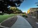 Community walking path lined with landscaping and foliage between attractive homes at 1350 S Greenfield Rd # 1219, Mesa, AZ 85206