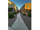 Community walkway winding between well maintained homes, enhancing neighborhood walkability at 1350 S Greenfield Rd # 1219, Mesa, AZ 85206