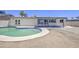 Backyard featuring a sparkling swimming pool, desert landscaping, and a covered patio, great for relaxation and entertainment at 14014 N 39Th Ave, Phoenix, AZ 85053