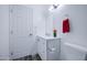 Clean bathroom with a white vanity, modern fixtures, and a well-lit mirror complemented by gray tile flooring at 14014 N 39Th Ave, Phoenix, AZ 85053