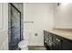 Modern bathroom boasts a glass-enclosed shower, toilet, and double vanity with stone countertops at 14014 N 39Th Ave, Phoenix, AZ 85053