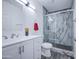 Bright bathroom showcasing a glass-enclosed shower with marble tile and a modern vanity with ample storage space at 14014 N 39Th Ave, Phoenix, AZ 85053