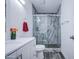 Modern bathroom featuring a stylish marble-tiled shower and a sleek, white vanity with contemporary fixtures at 14014 N 39Th Ave, Phoenix, AZ 85053