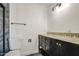 Bathroom featuring a double vanity with dark cabinetry, granite countertops, and stylish fixtures at 14014 N 39Th Ave, Phoenix, AZ 85053